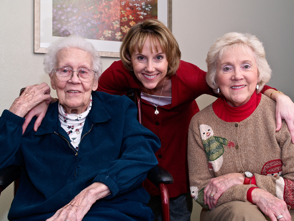 Nursing and two elderly woman smiling.