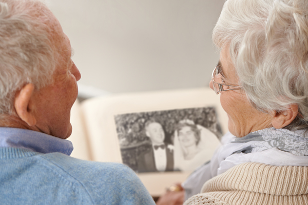 Elderly couple looking at thier wedding photo